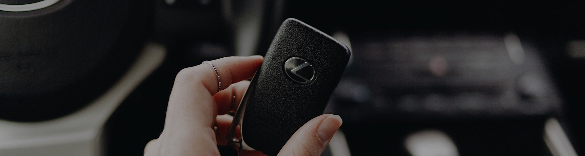 Car key held in a hand inside a vehicle interior